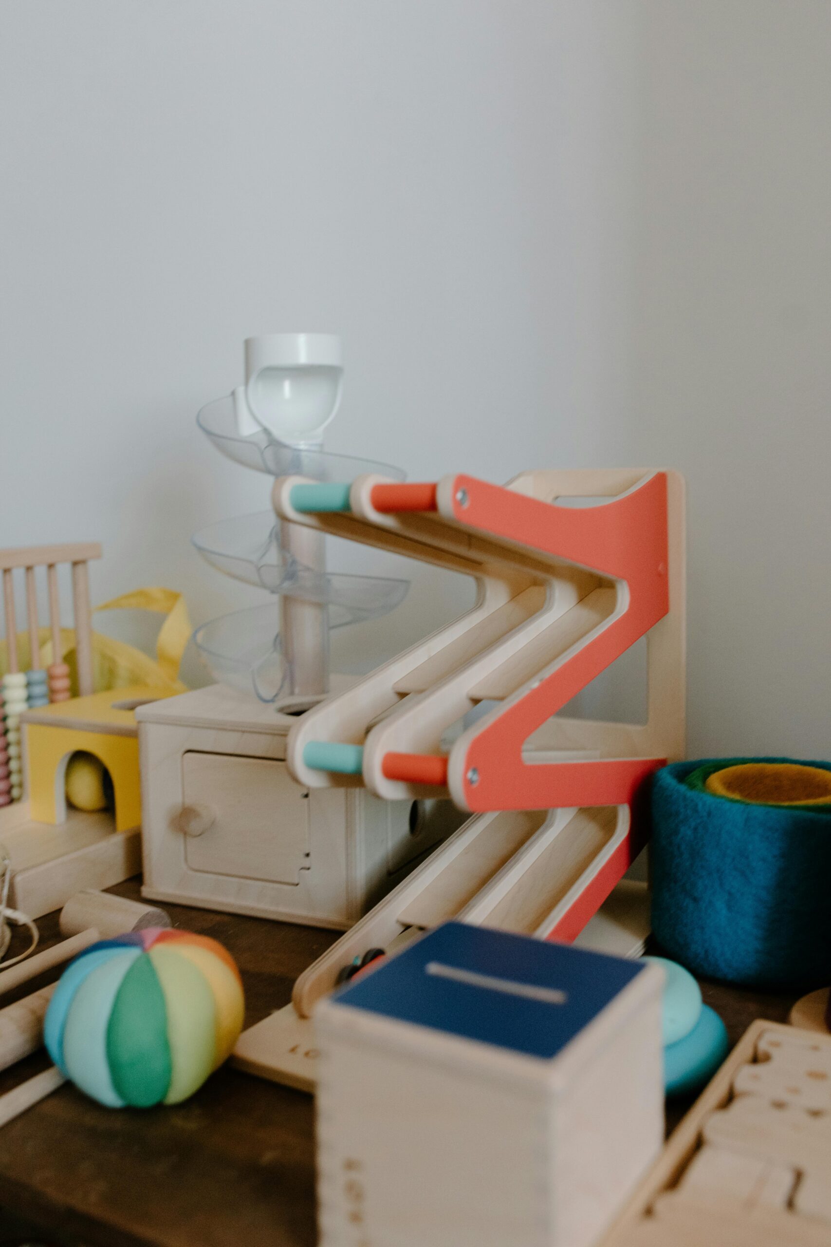 A collection of colorful wooden educational toys for children — books, blocks, and Montessori-inspired play items.